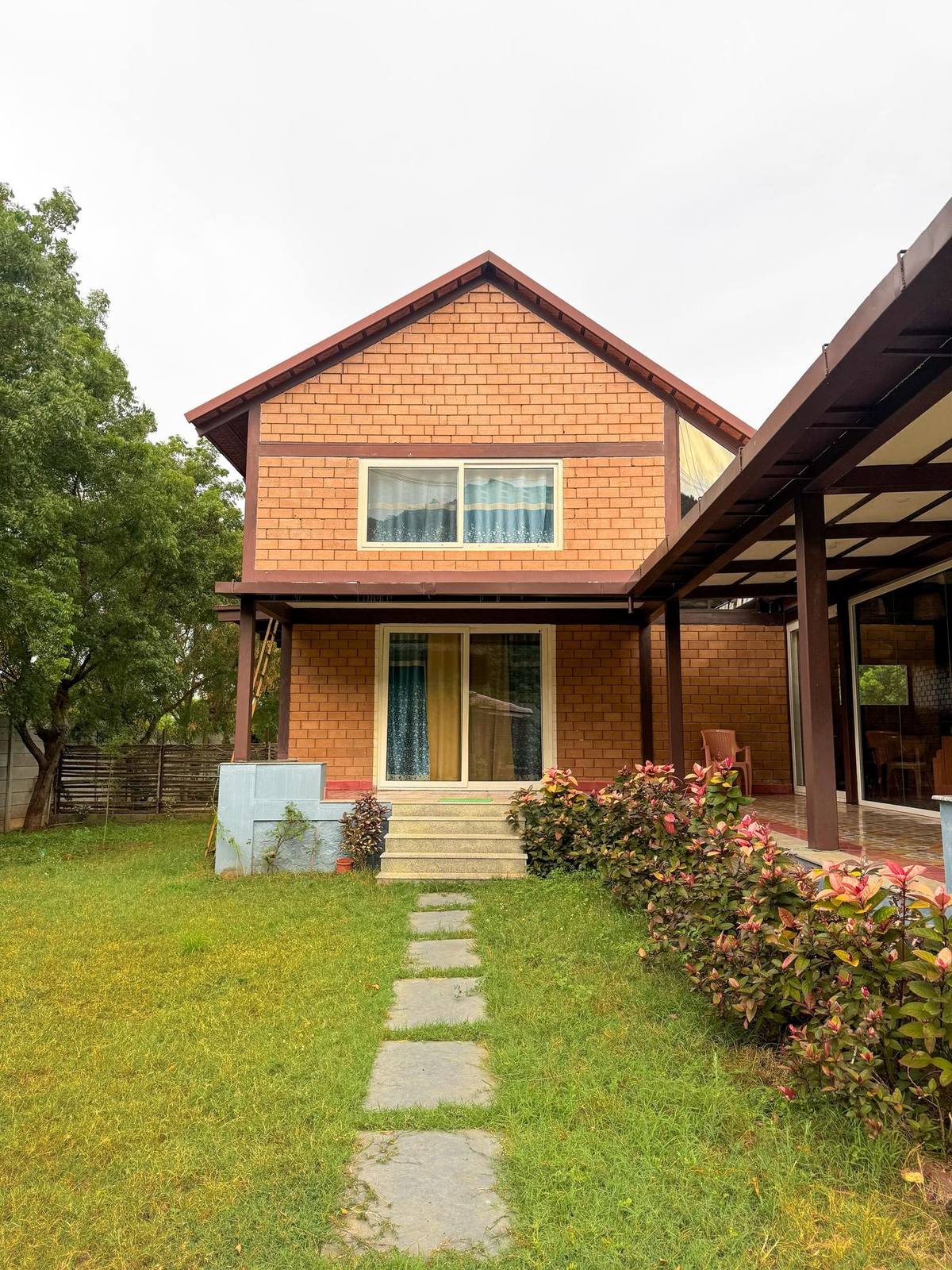 Cottage with mountain backdrop at Jeevajyothi Farms